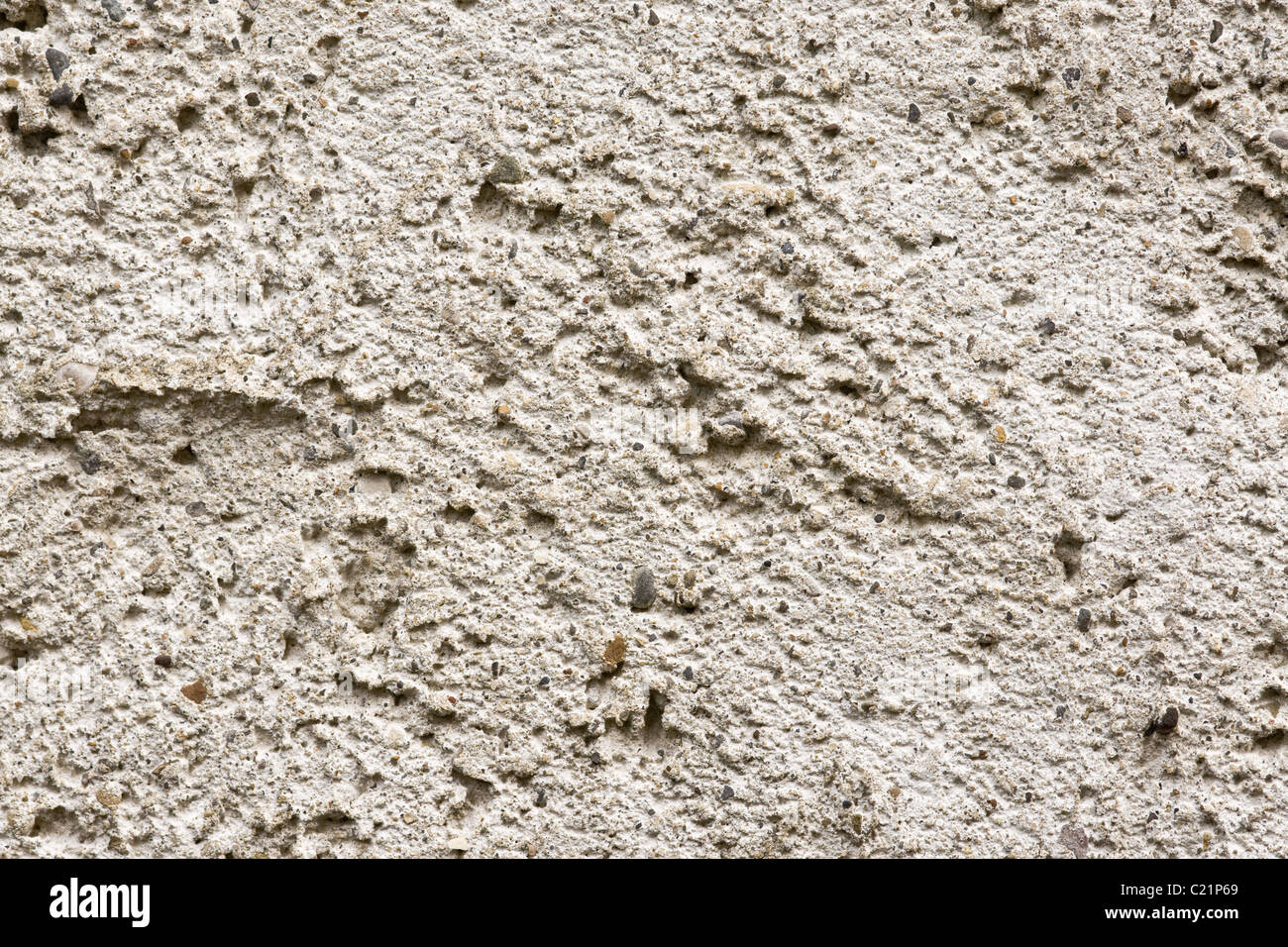 texture on the concrete and pebble render on the wall of a building. Stock Photo