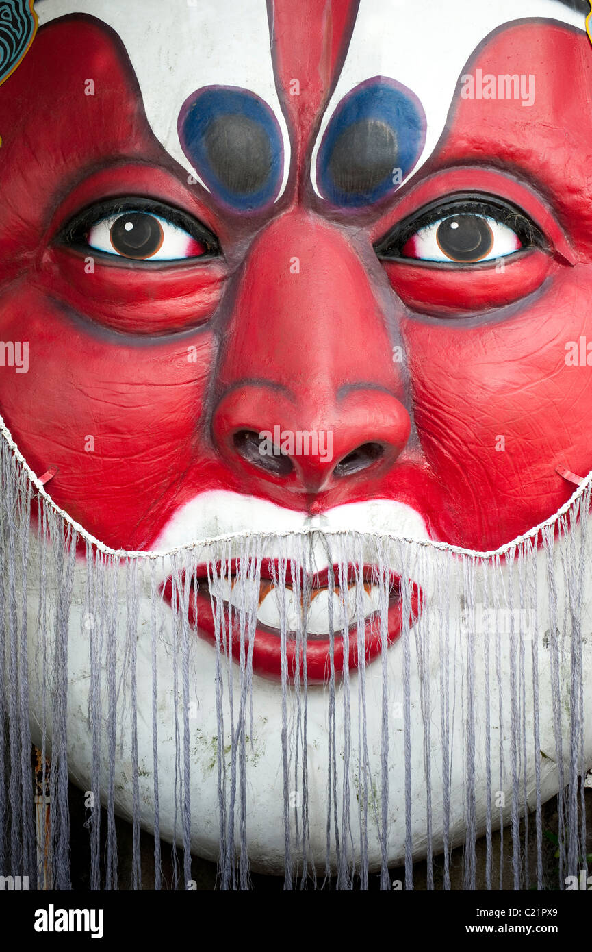A large oriental face sculpture at Haw Par Villa, the former Tiger Balm Gardens. An unusual oriental themed park in Singapore Stock Photo
