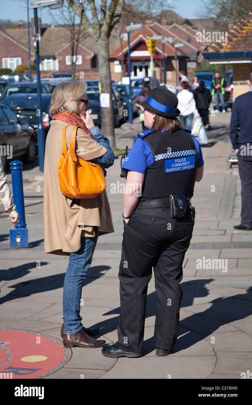 female police community support officer talking to woman Stock Photo