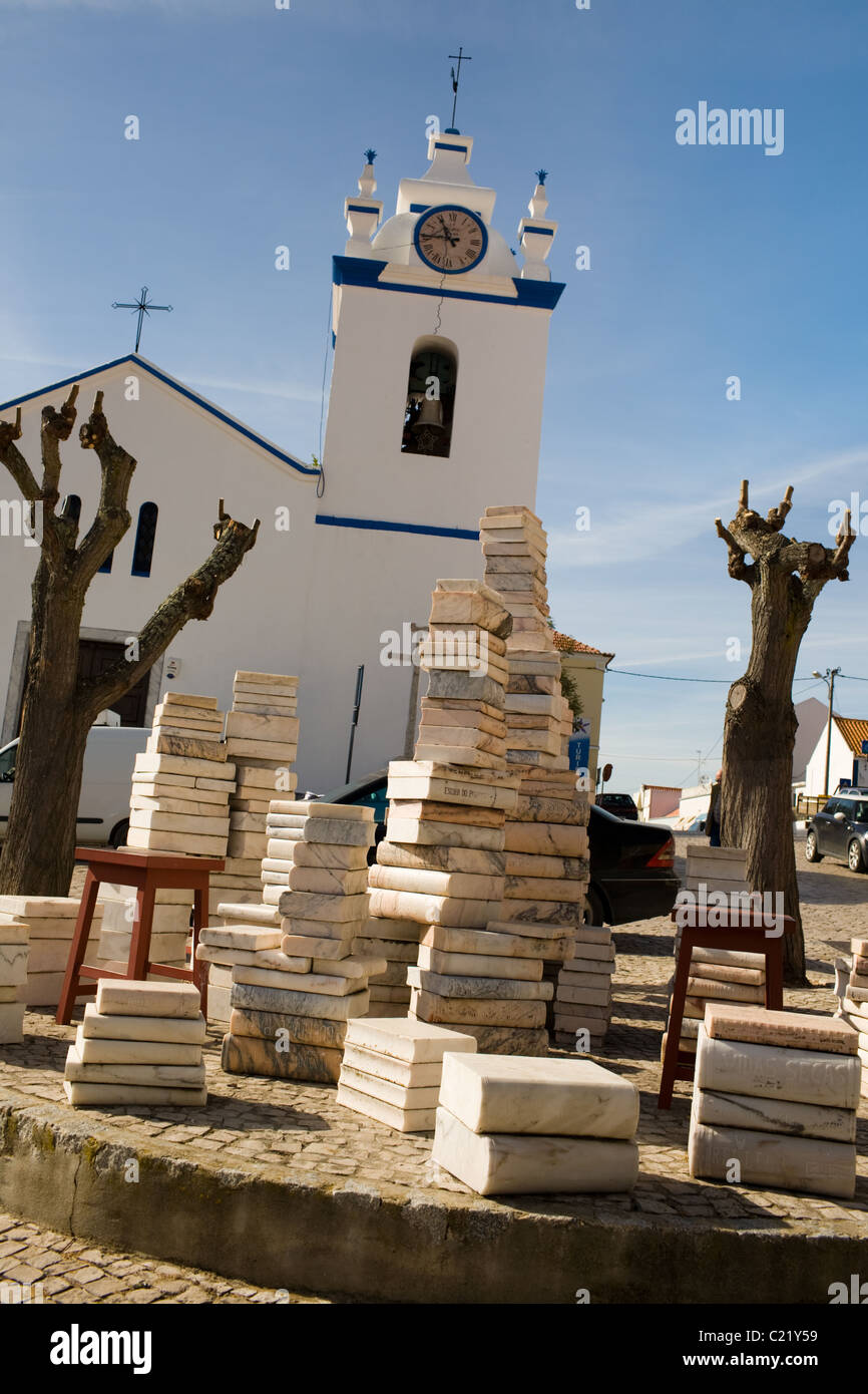 Whimsical sculpture in marble of stacks of books grace town square in Melides, Portugal, Alentejo Region Stock Photo