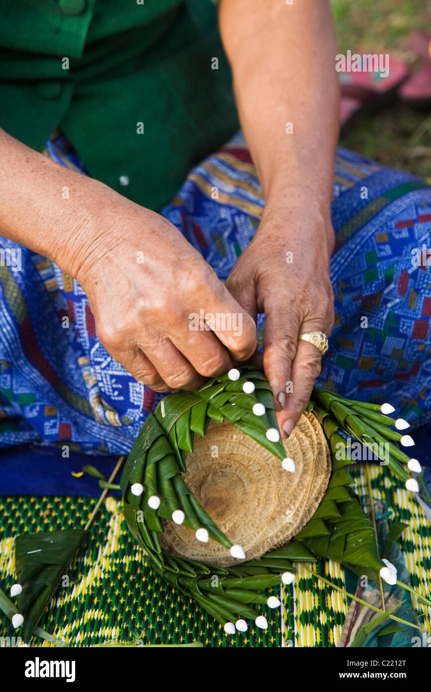 A woman creates krathong (small rafts) from banana trunk.  Sukhothai, Sukhothai, Thailand Stock Photo