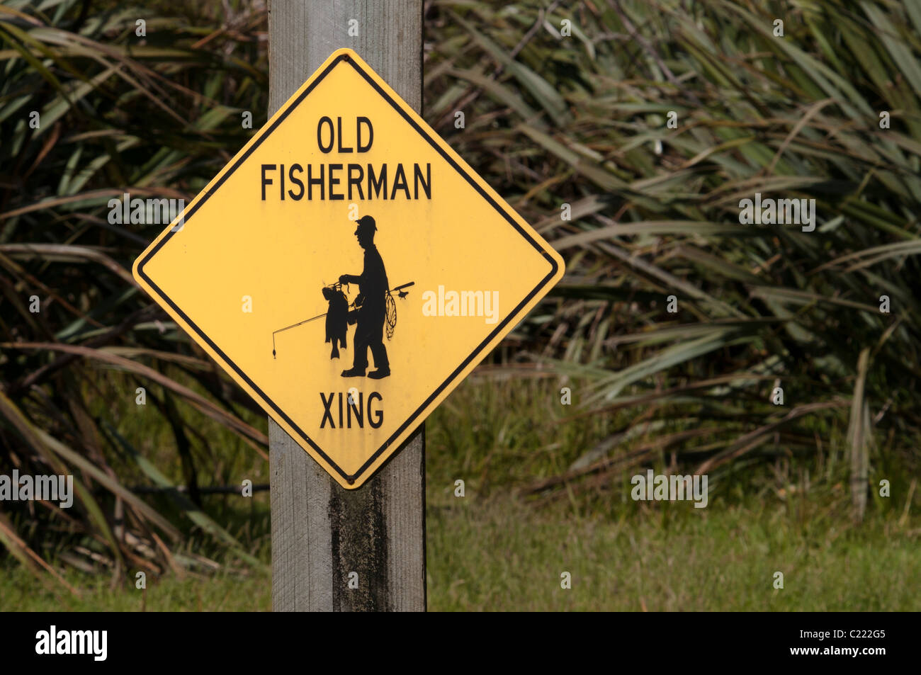 Be carefull - old fishermen might cross the road !  Achtung! Ältere Fischer könnten unterwegs sein! Stock Photo
