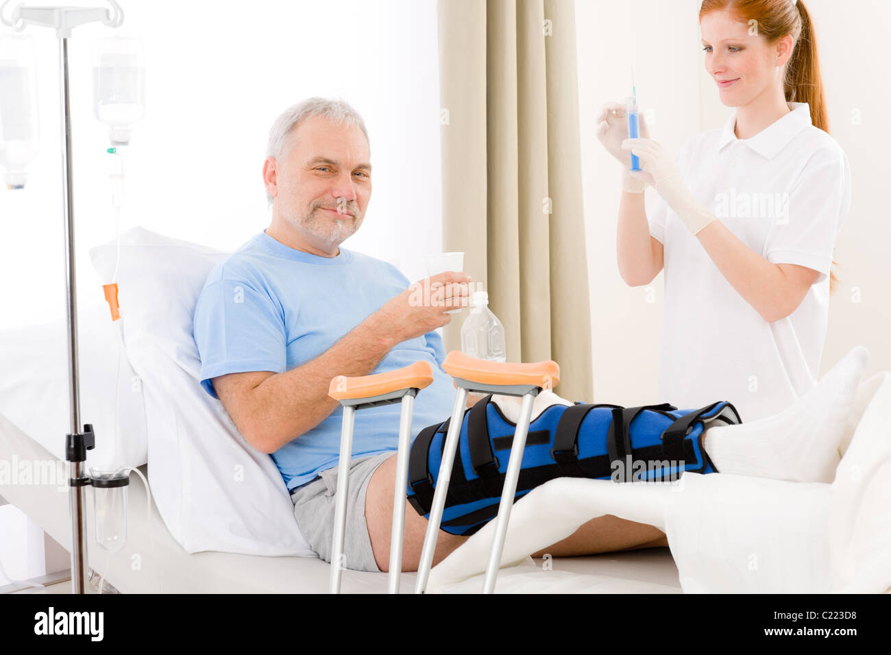 Hospital - female nurse give injection patient with broken leg Stock ...