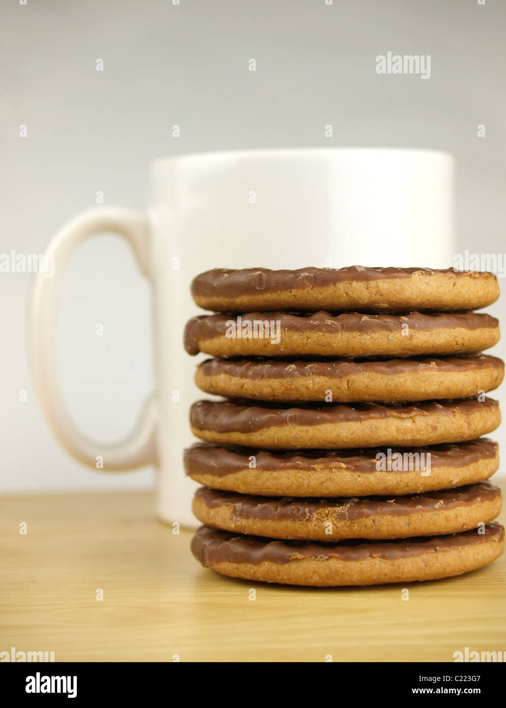 Mug of coffee and a pile of chocolate biscuits Stock Photo