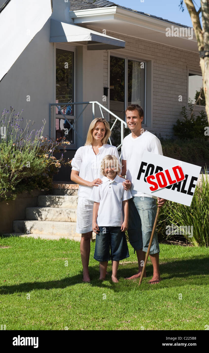 Happy family in front of their new house Stock Photo - Alamy