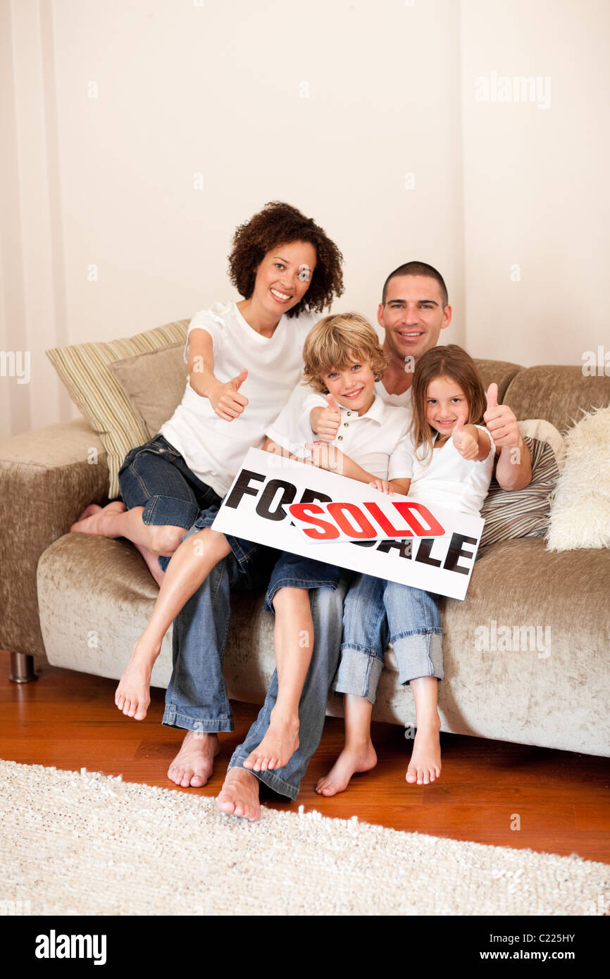 Happy family sitting on the couch Stock Photo - Alamy