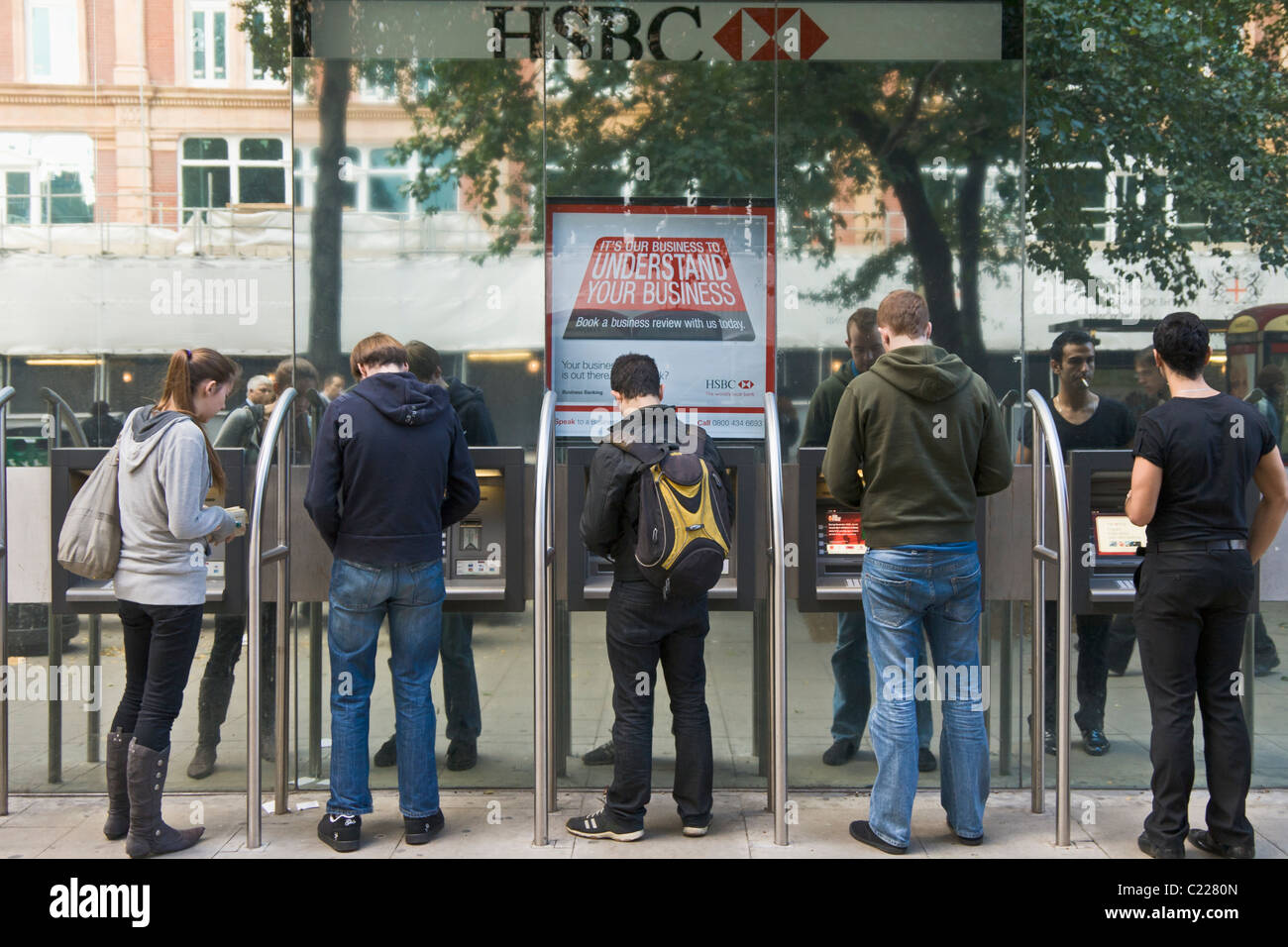 People withdrawing money from ATM, London, England Stock Photo