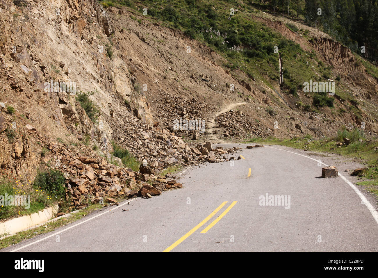 Rock slide on paved road, Pisac, Peru Stock Photo