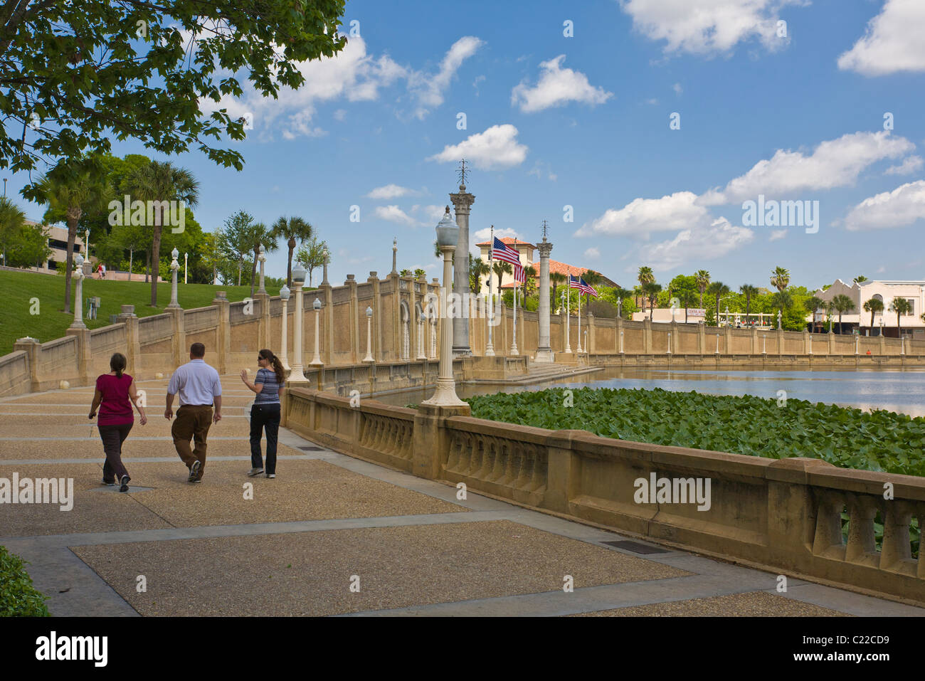 People walking in park around Lake Mirror in Lakeland Florida Stock Photo