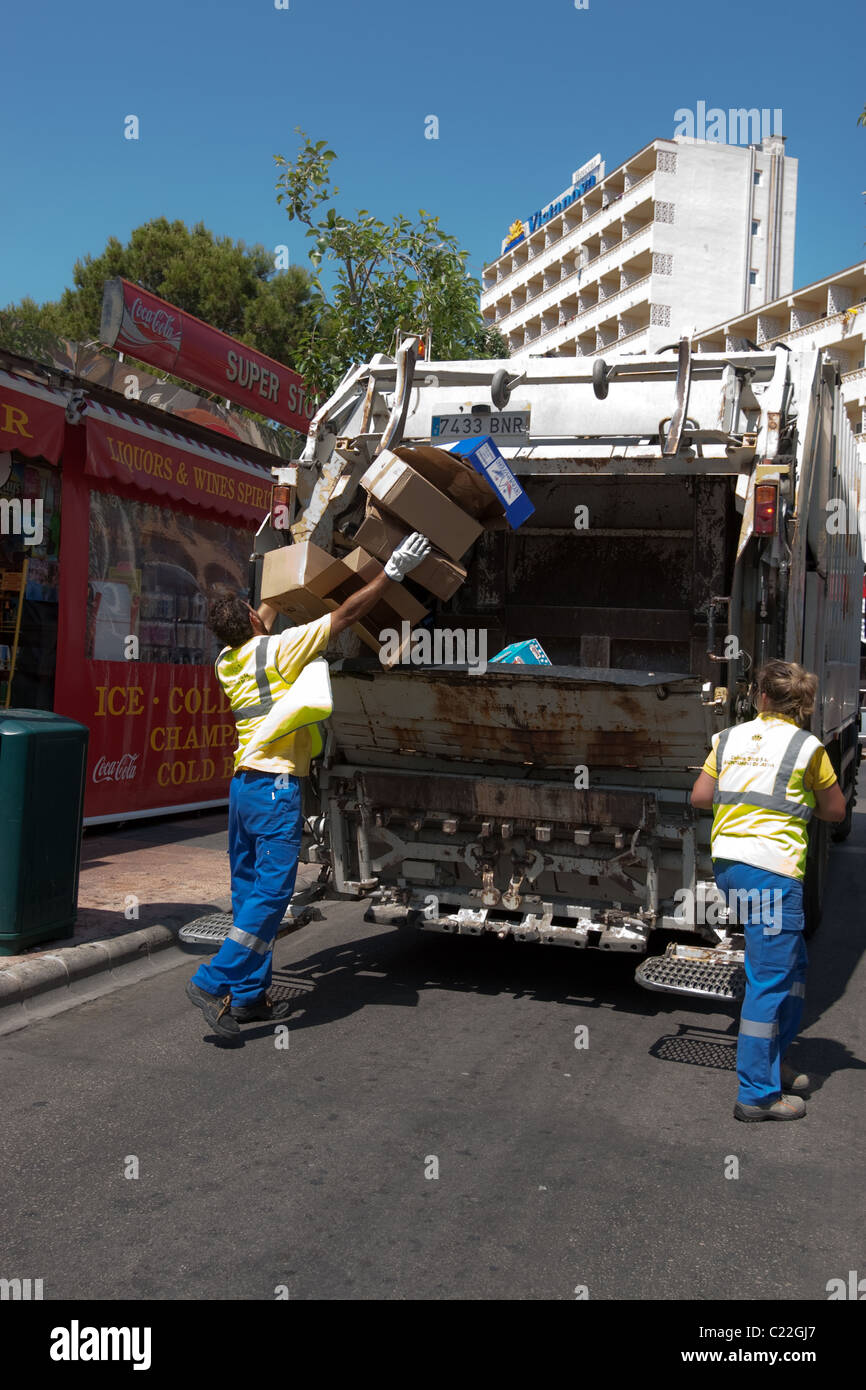 Cleaner workers on work in street with garbage truck cleaning Mallorca