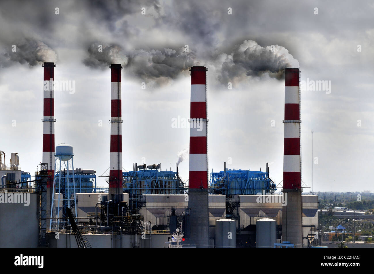 Industrial smokestacks blowing smoke into the environment Stock Photo