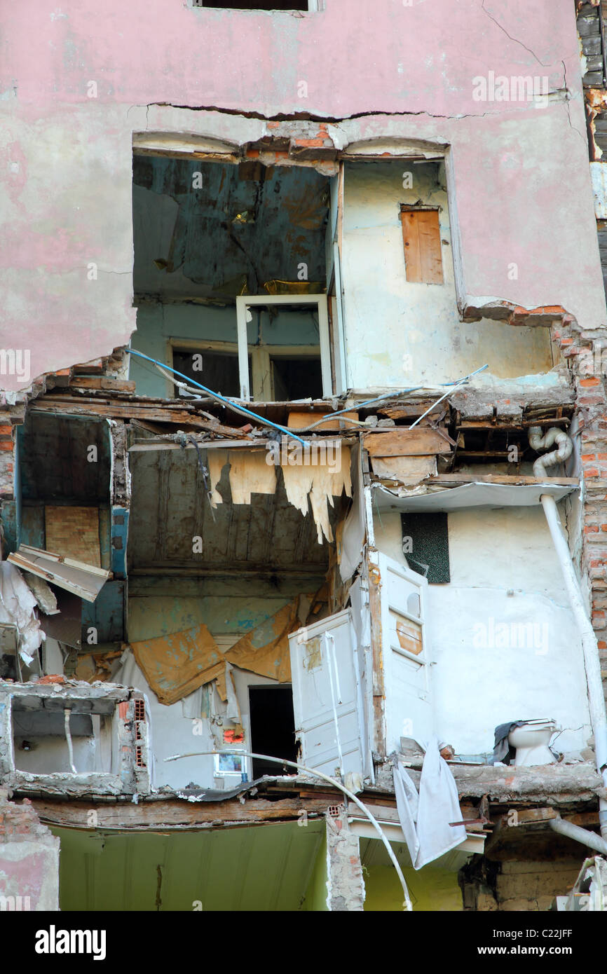 broken down apartment house with the facade missing affording views in rooms and toilet Stock