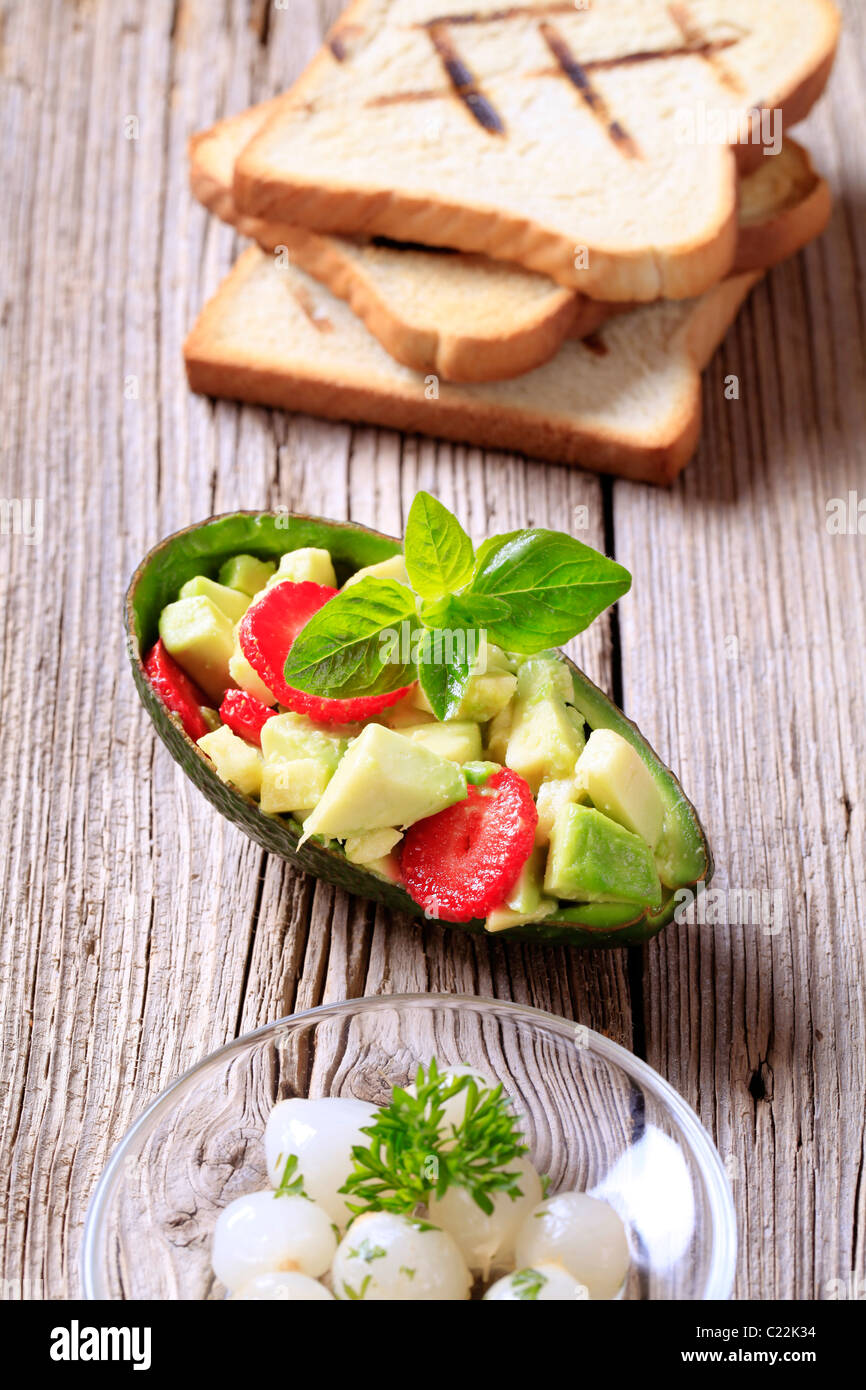 Avocado salad, pickled onions and toasted bread Stock Photo