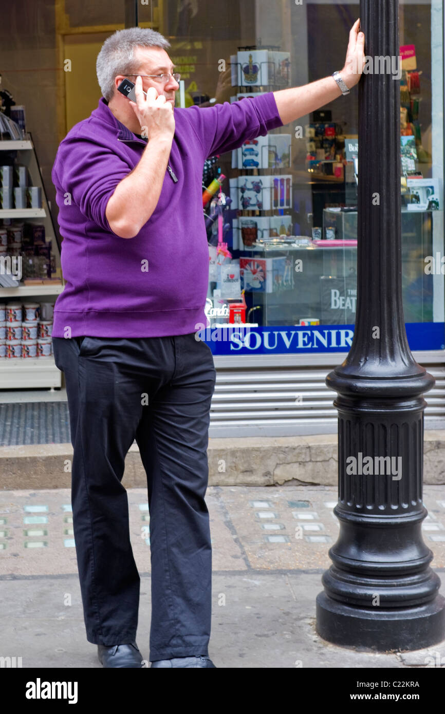 Middle aged man with grey or gray hair in purple sweater glasses