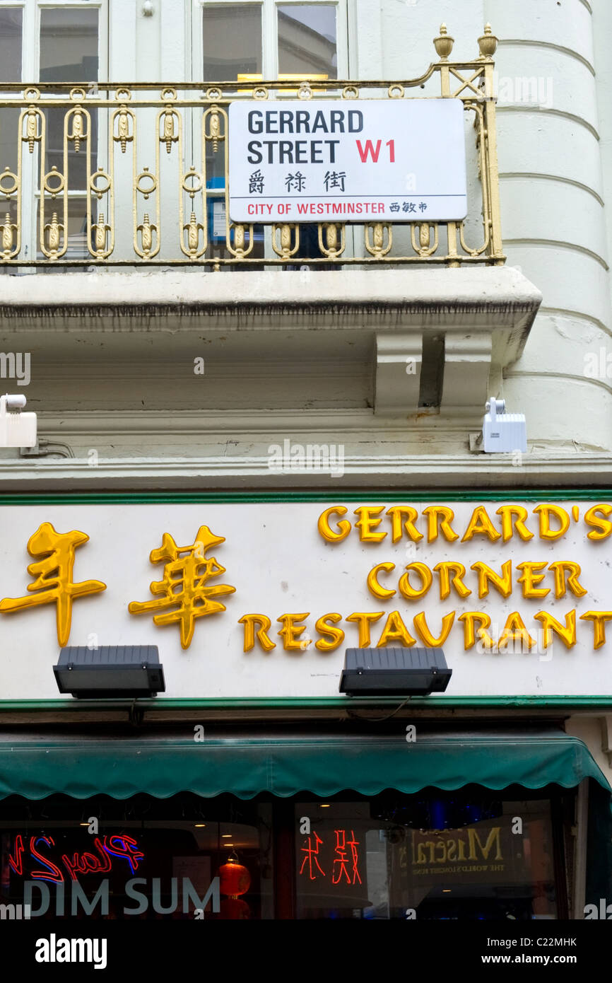 China Town , Gerrard Street sign by Gerrard's Corner Chinese oriental dim sum restaurant both in Chinese & English script Stock Photo