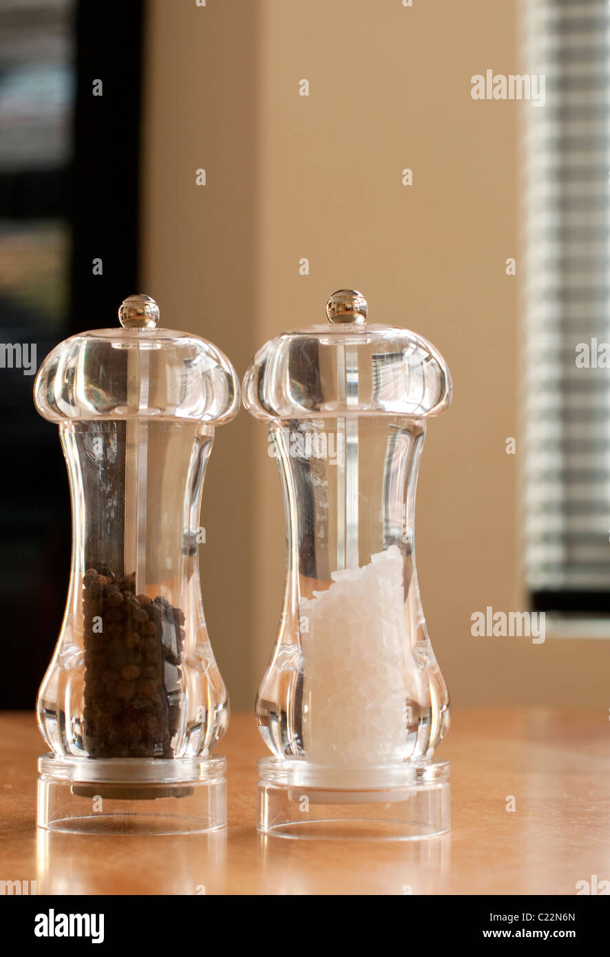 Salt and pepper pots on kitchen table Stock Photo