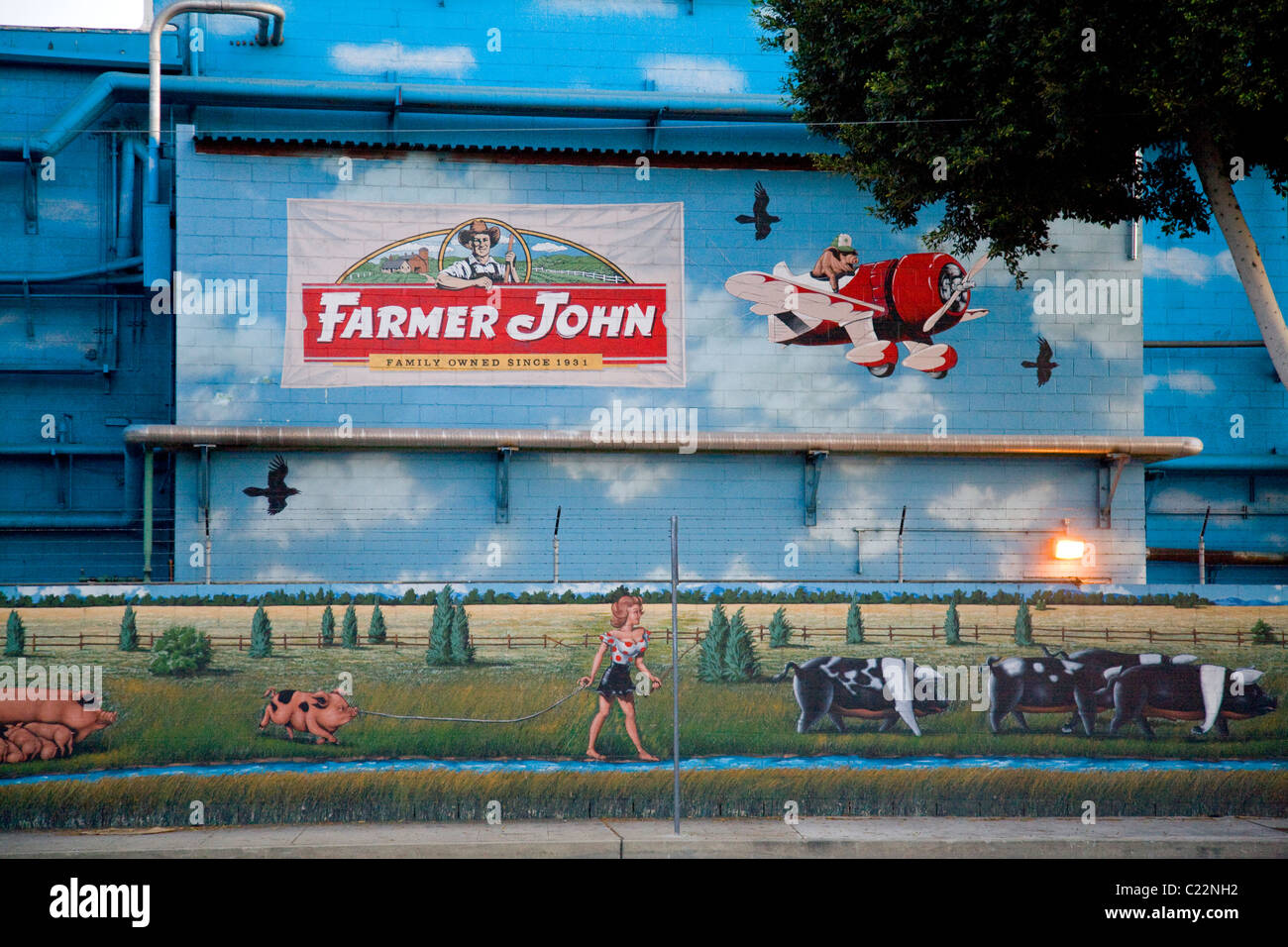 Mural on the side Farmer John meat processing plant in Vernon. Los