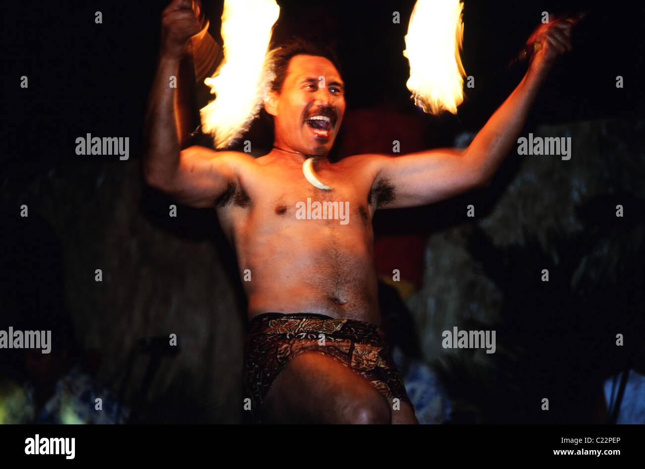 Man with flaming torches Hawaii Hula performance Stock Photo