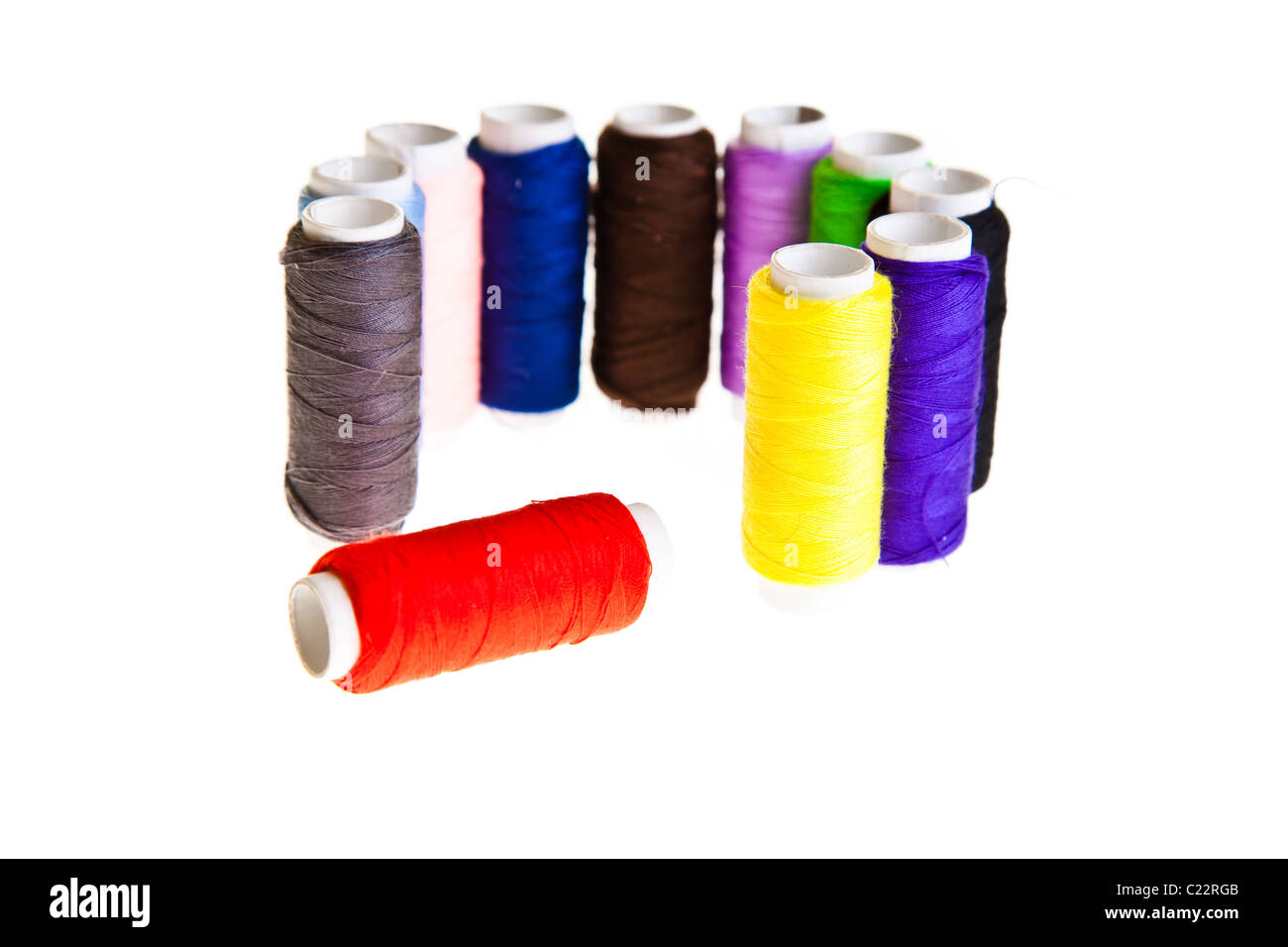 Colorful sewing threads and tools on white isolated background Stock
