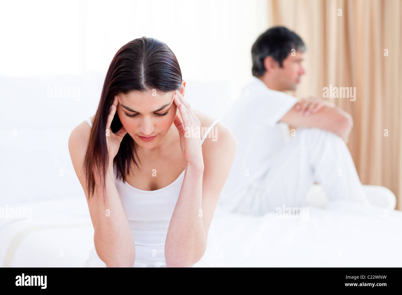 Sad couple having an argument sitting on bed Stock Photo - Alamy
