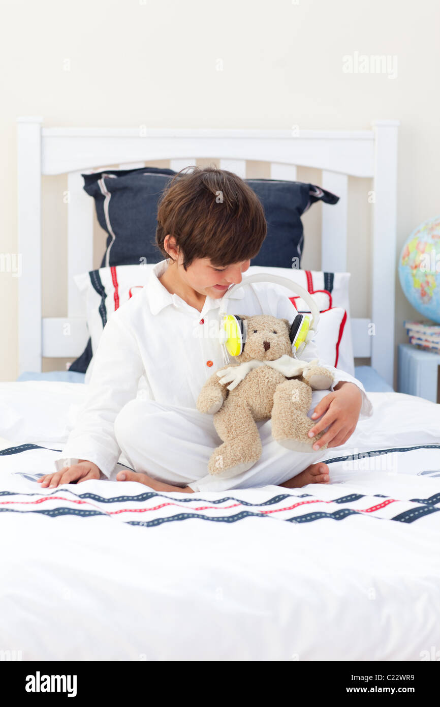 Cute little boy playing with a teddy bear Stock Photo - Alamy