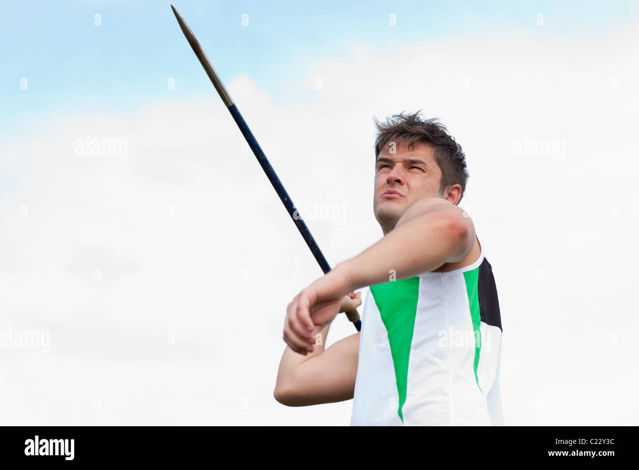 Determined sportsman throwing the javelin Stock Photo Alamy