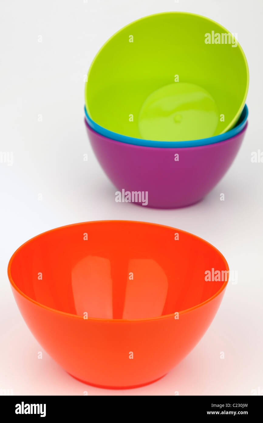 Four different brightly coloured plastic picnic bowls Stock Photo