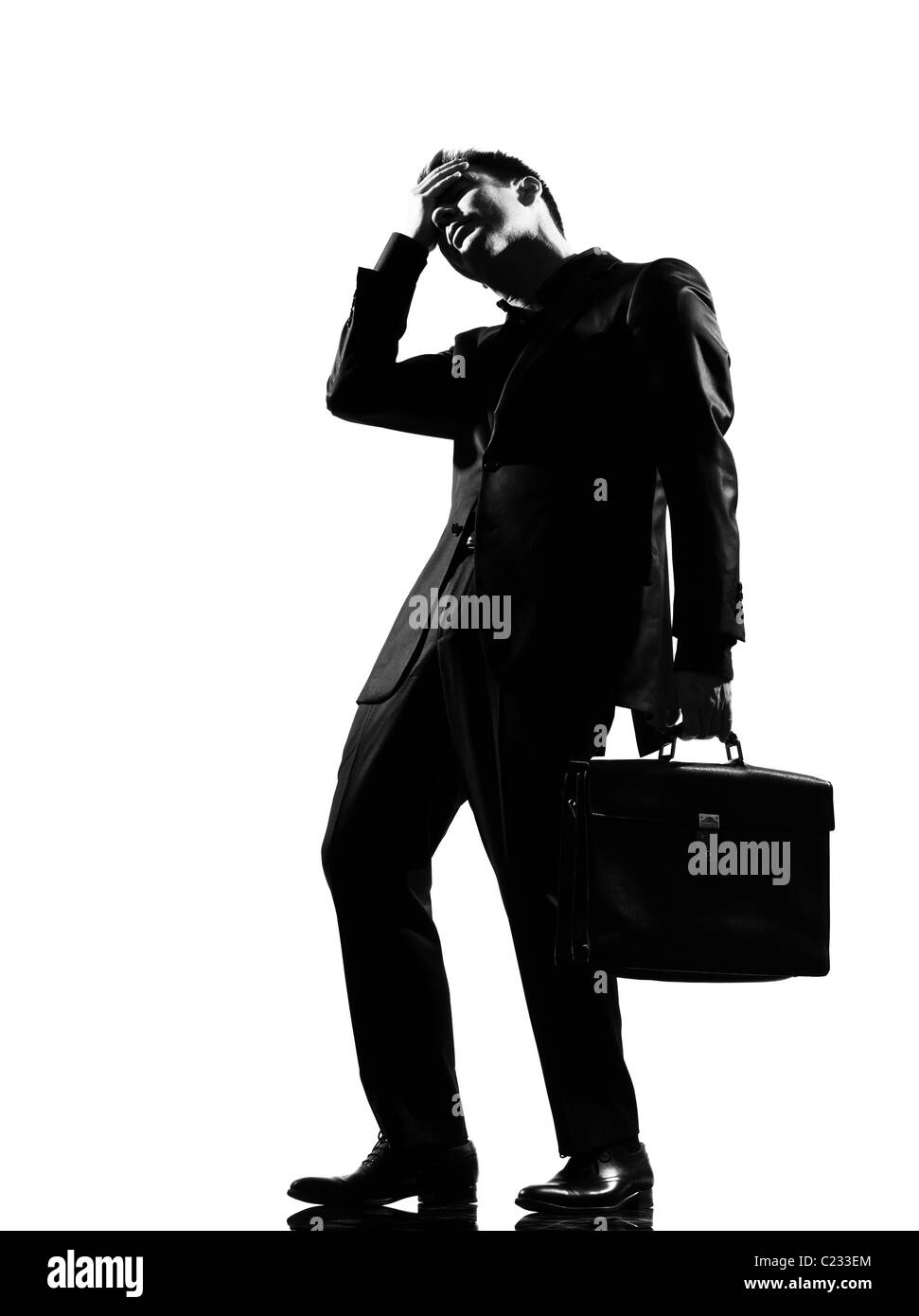 silhouette caucasian business man expressing fatigue despair tired behavior full length on studio isolated white background Stock Photo