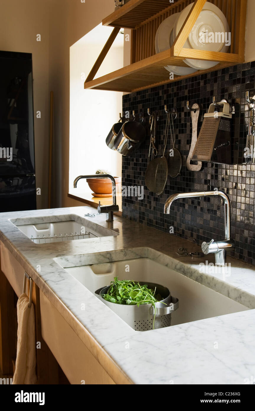 Double butler sinks with marble surface area in farmhouse kitchen Stock Photo