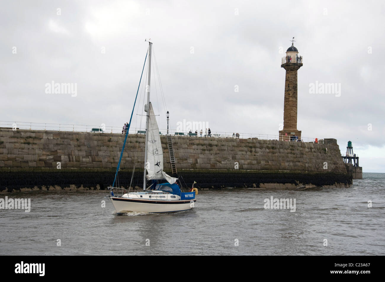 Yacht entering the harbour at Whitby, North Yorkshire, England Stock ...