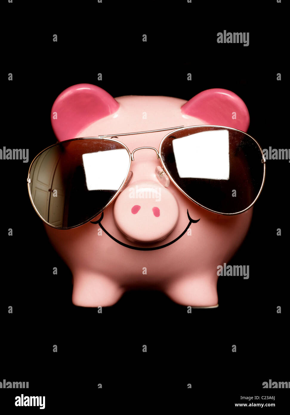 Piggy bank with sunglasses isolated on black Stock Photo