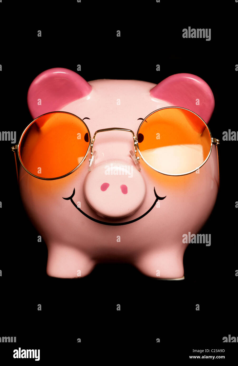 Piggy bank with sunglasses isolated on black Stock Photo