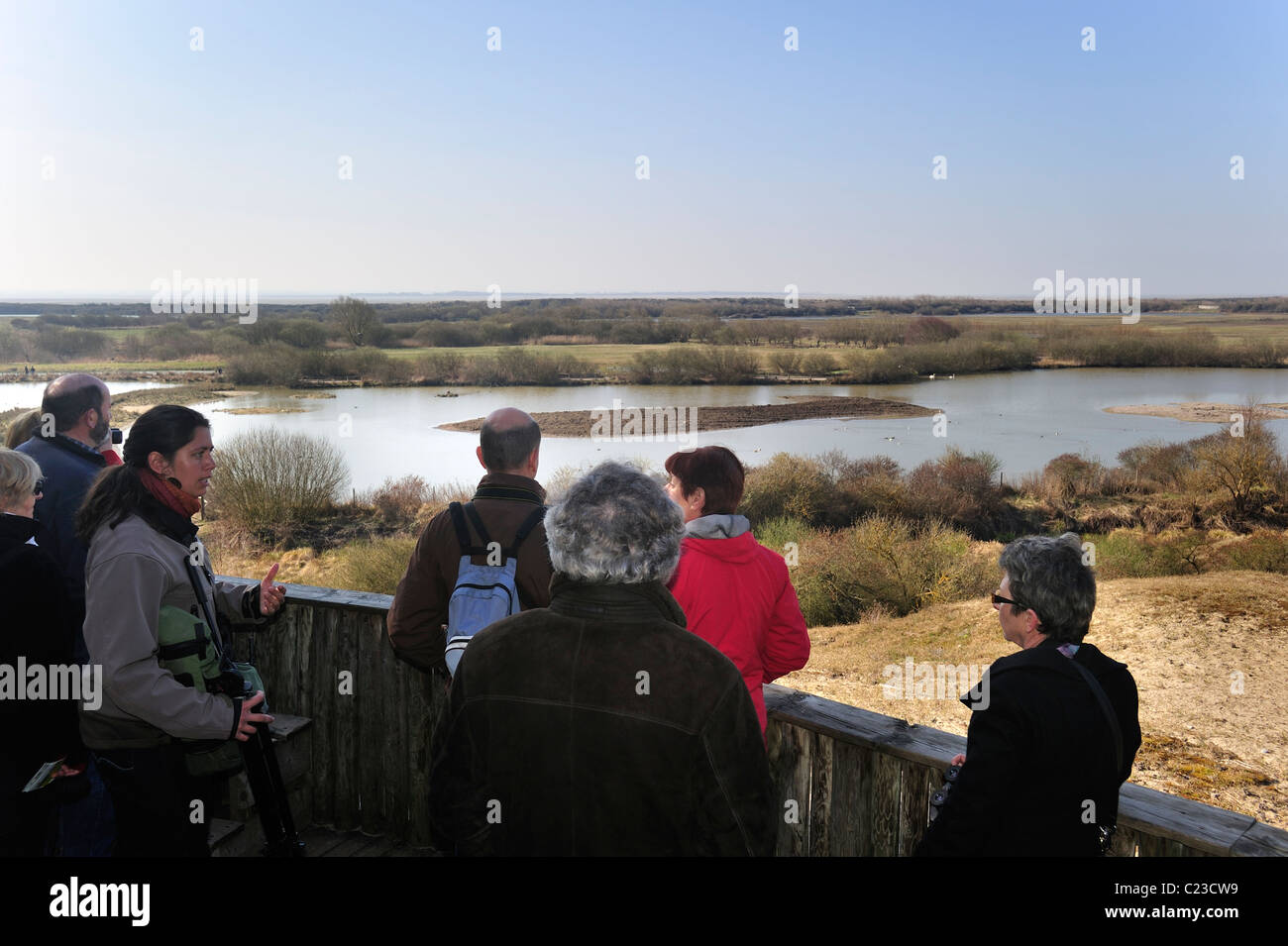 Guide and birdwatchers at viewpoint looking over nature reserve Parc du Marquenterre at the Bay of the Somme, Picardy, France Stock Photo