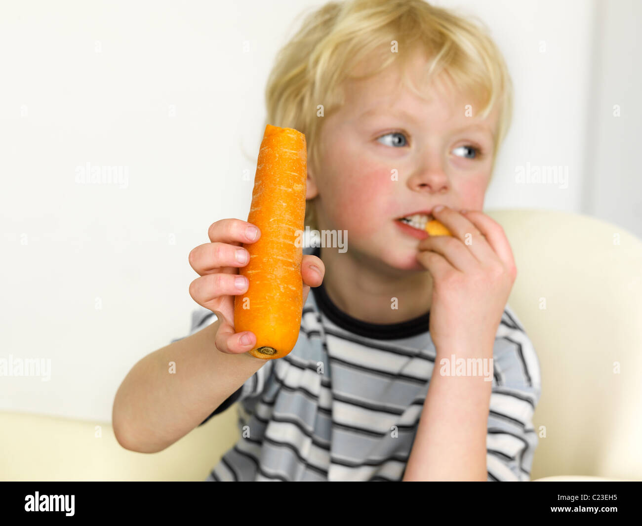 Young boy eating Carrot Model release all media Stock Photo Alamy