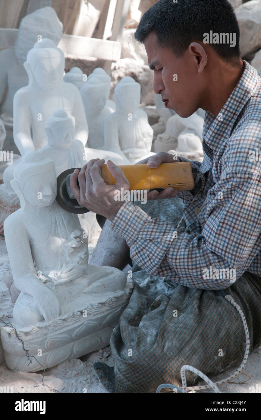 Man carving Budha in white stone. Mahamuni pagoda. Mandalay. Myanmar Stock Photo