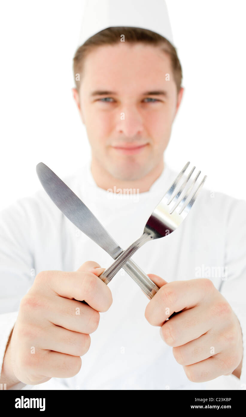 Handsome cook holding cutlery Stock Photo Alamy