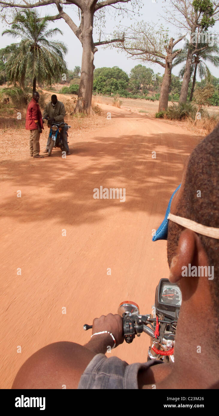 Riding pillion on a motorbike near Banfora in Burkina Faso, west Africa Stock Photo