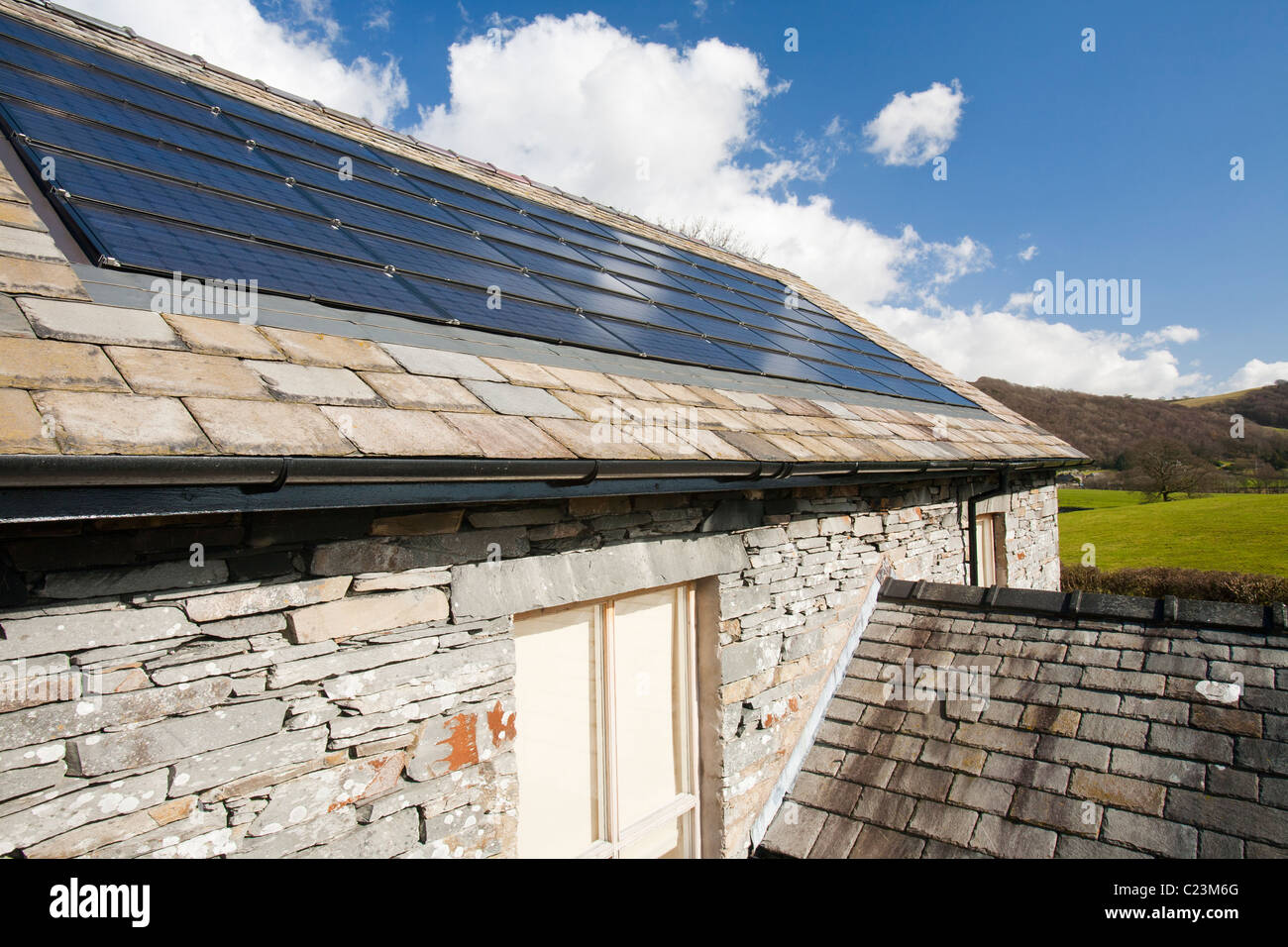 Solar electric panels on Lowick Village Hall in South Cumbria, UK. Stock Photo
