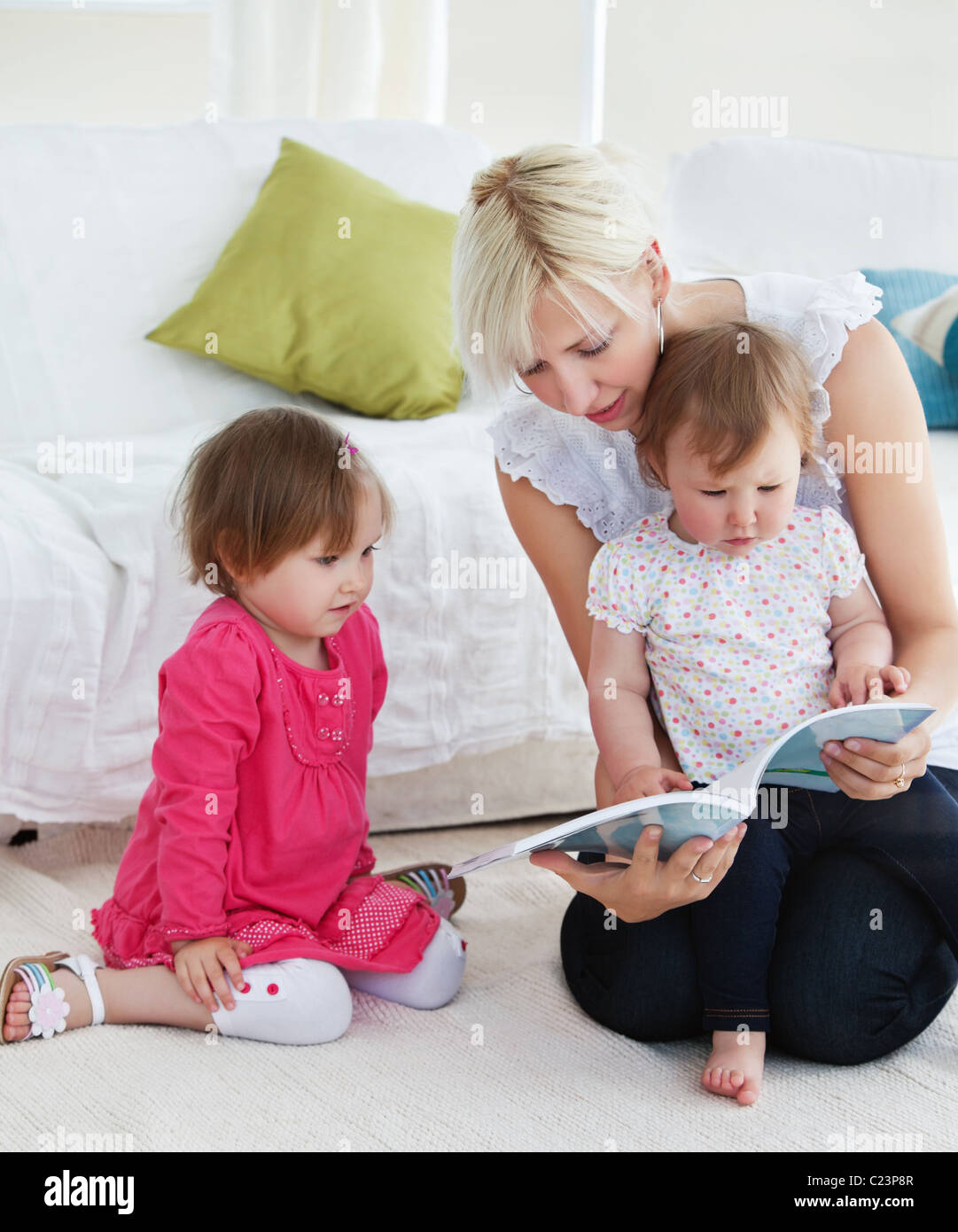 Small family reading a book Stock Photo