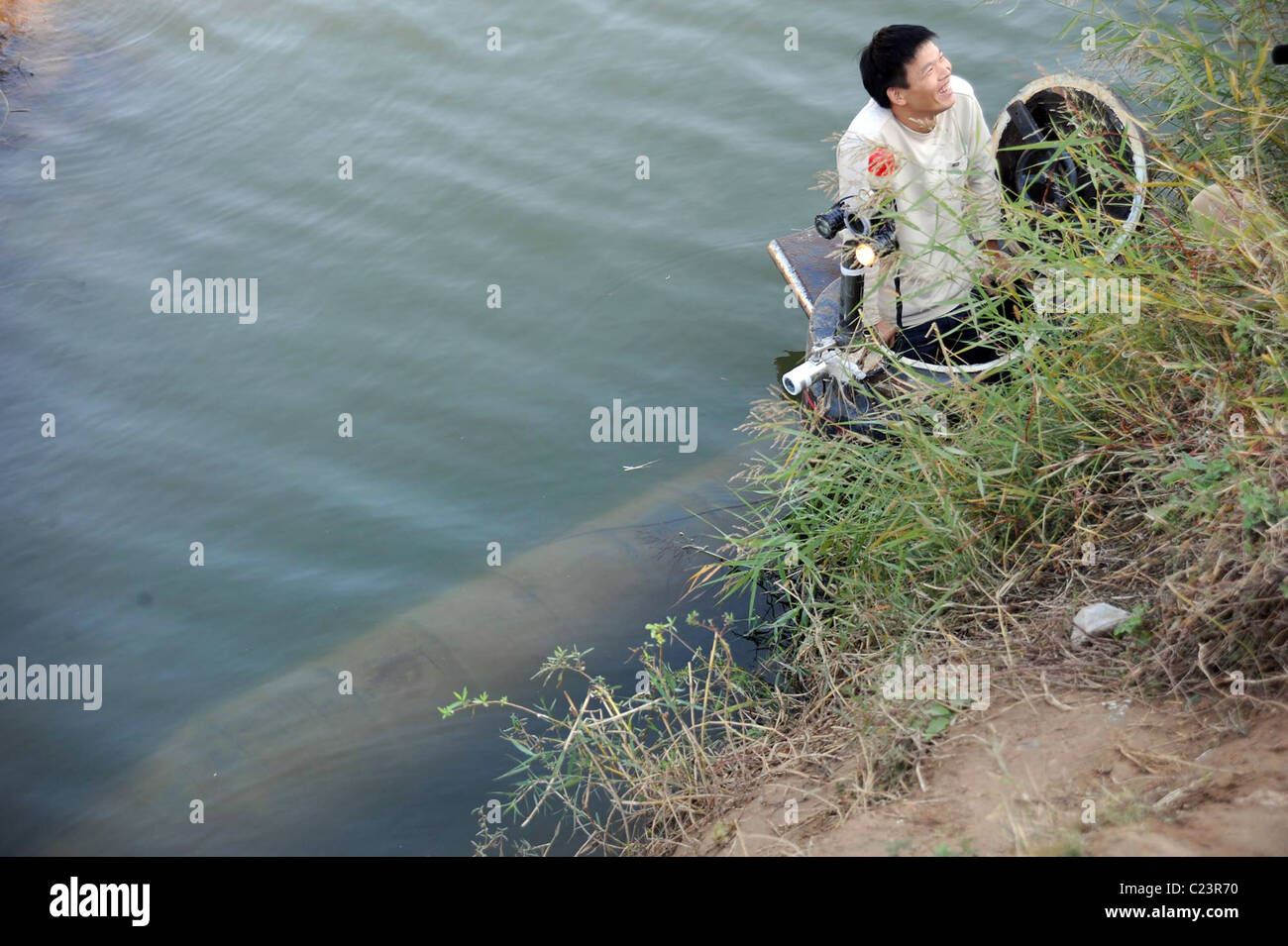 MAN BUILDS OWN SUB Madcap inventor Tao Xiangli is all at sea - he has built his own submarine. The boat-crazy 34-year-old Stock Photo