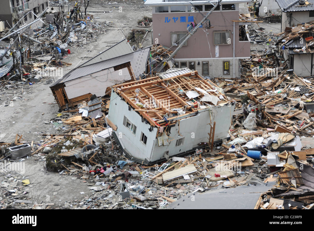 (March 15, 2011) An upended house is among debris in Ofunato, Japan, following a 9.0 magnitude earthquake and tsunami Stock Photo