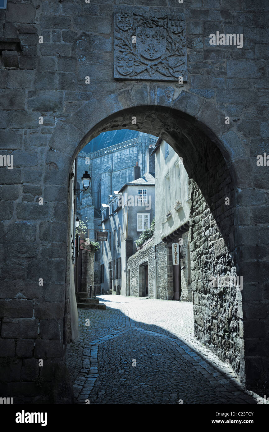 Street scene France - French typical old medieval cobbled street through an arch in the city walls in Vannes, Morbihan, Brittany, France Stock Photo