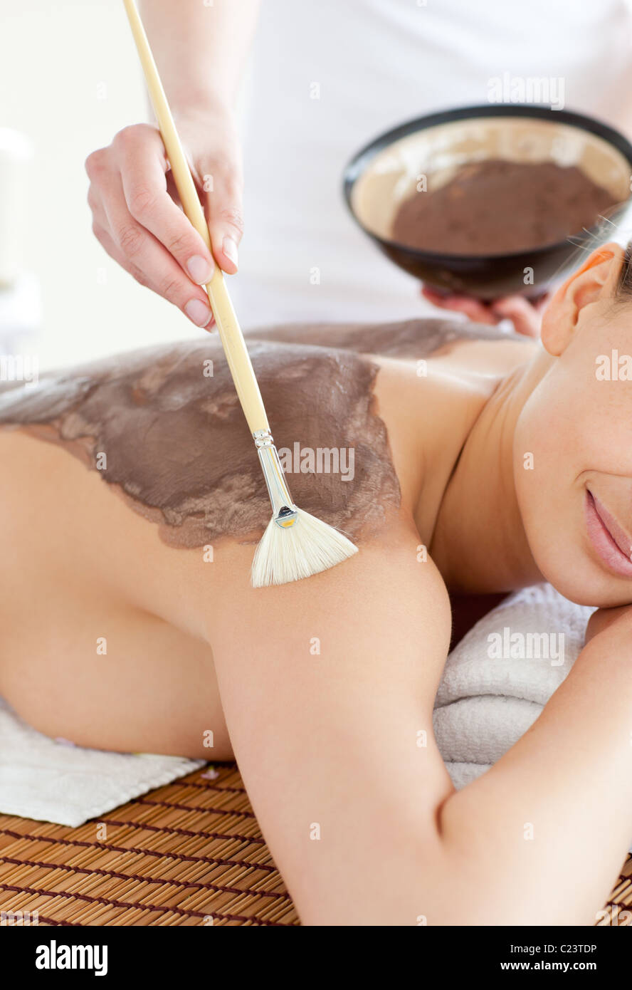 Charming woman enjoying a mud skin treatment Stock Photo