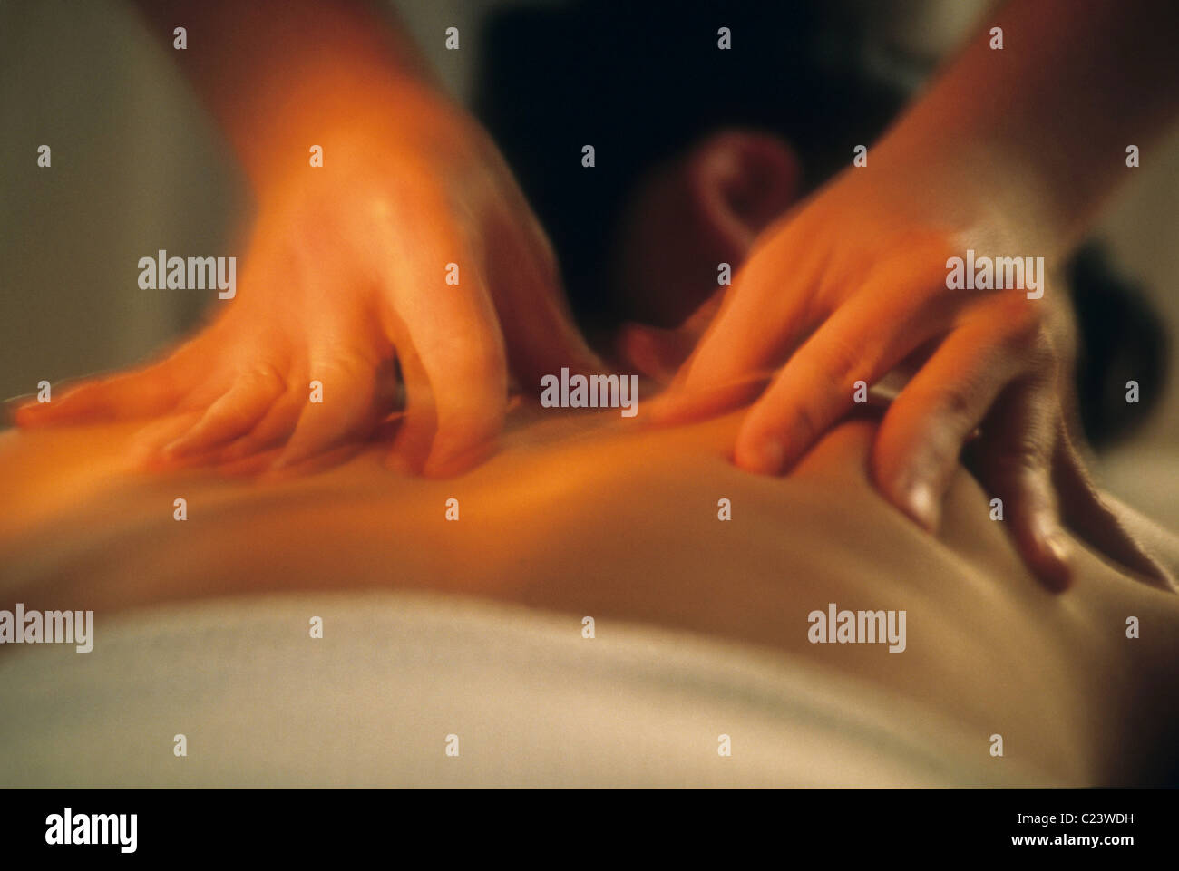 Masseuse massages client. Stock Photo