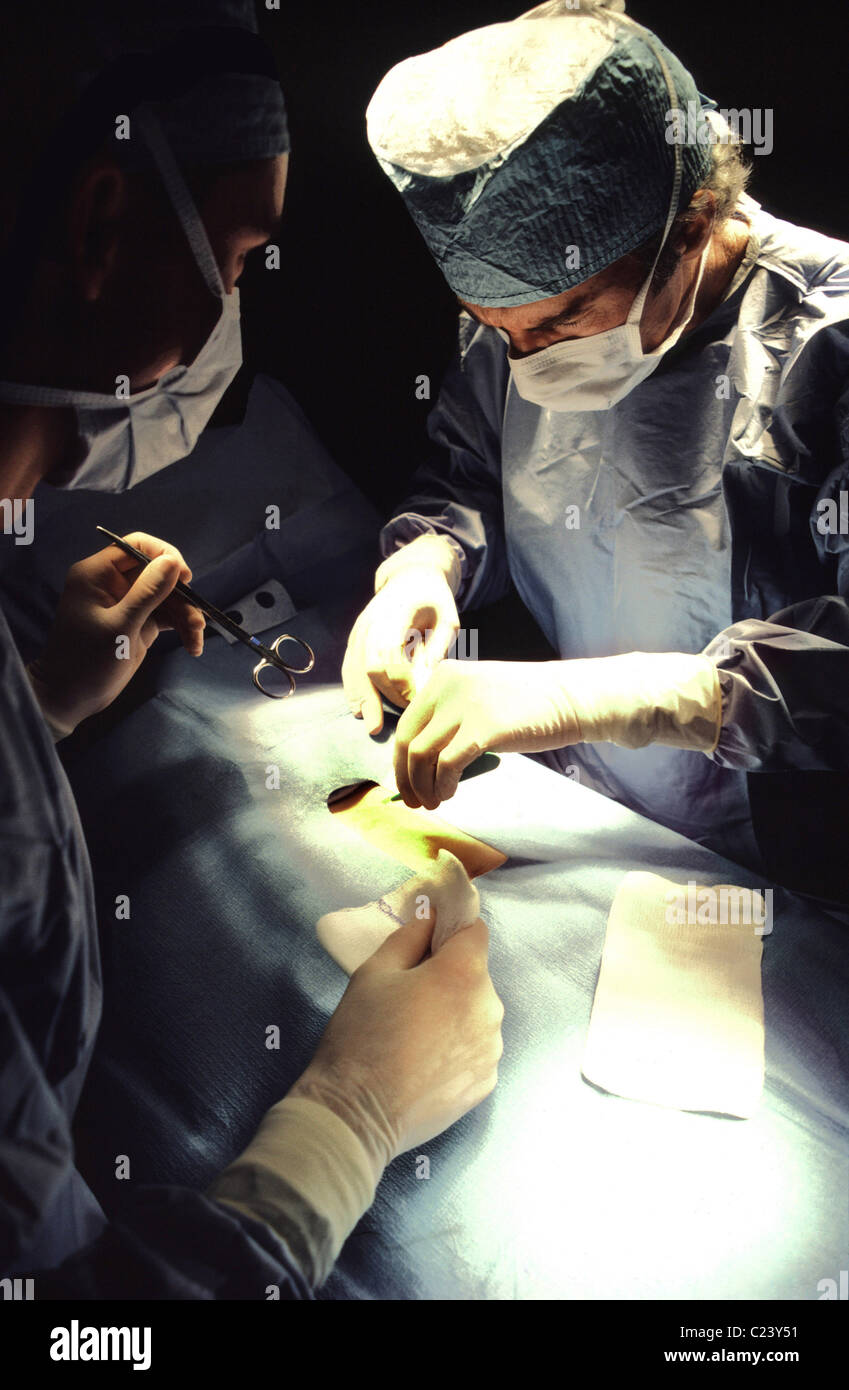 Surgeons in operating room. Stock Photo