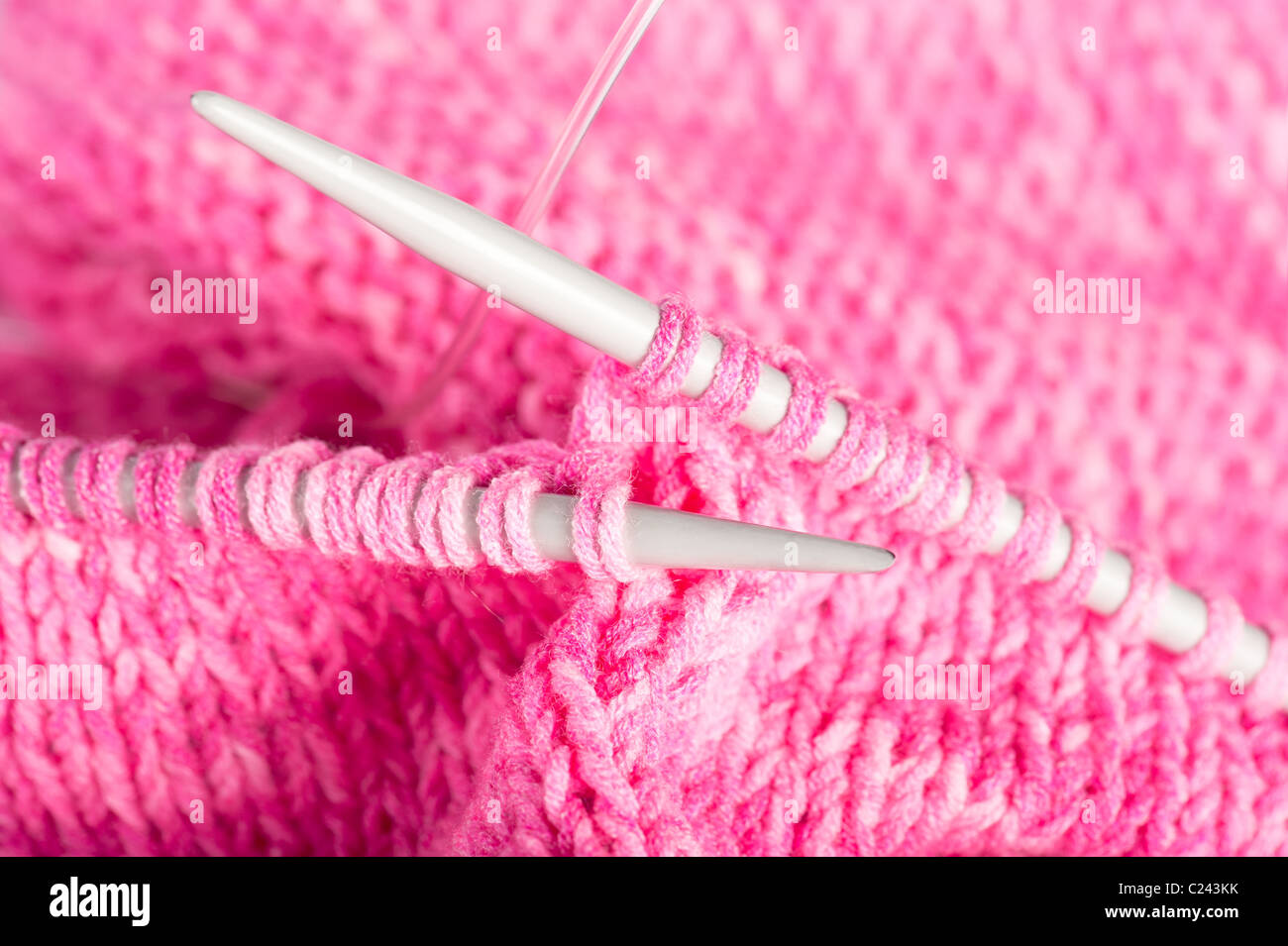 Handmade needle knitted pink canvas background. SDOF Stock Photo
