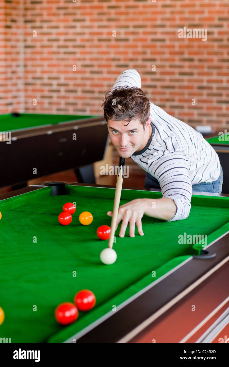 Assertive young man playing snooker Stock Photo