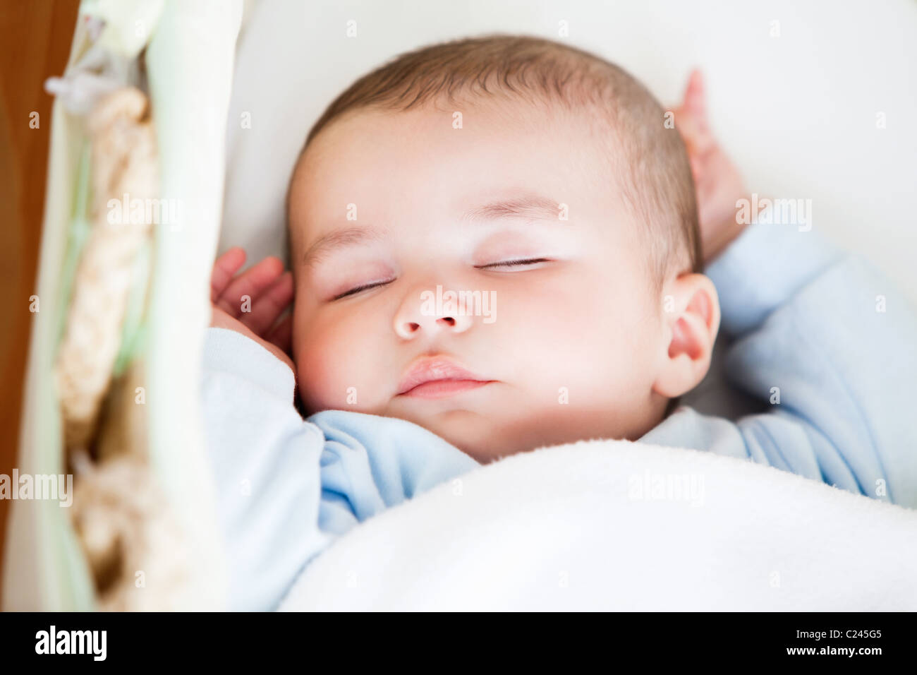 Portrait of a sleeping baby lying in his cradle Stock Photo Alamy