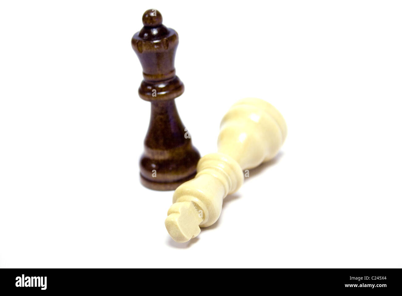 Chess pieces black queen white king down wood check mate topple win ...