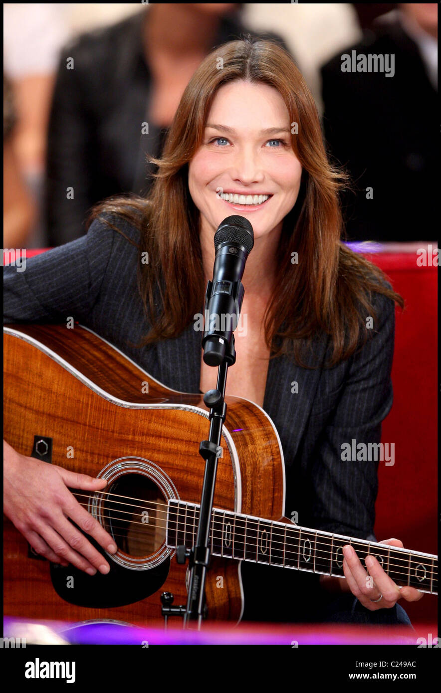 Carla Bruni Sarkozy playing a guitar on the French television show